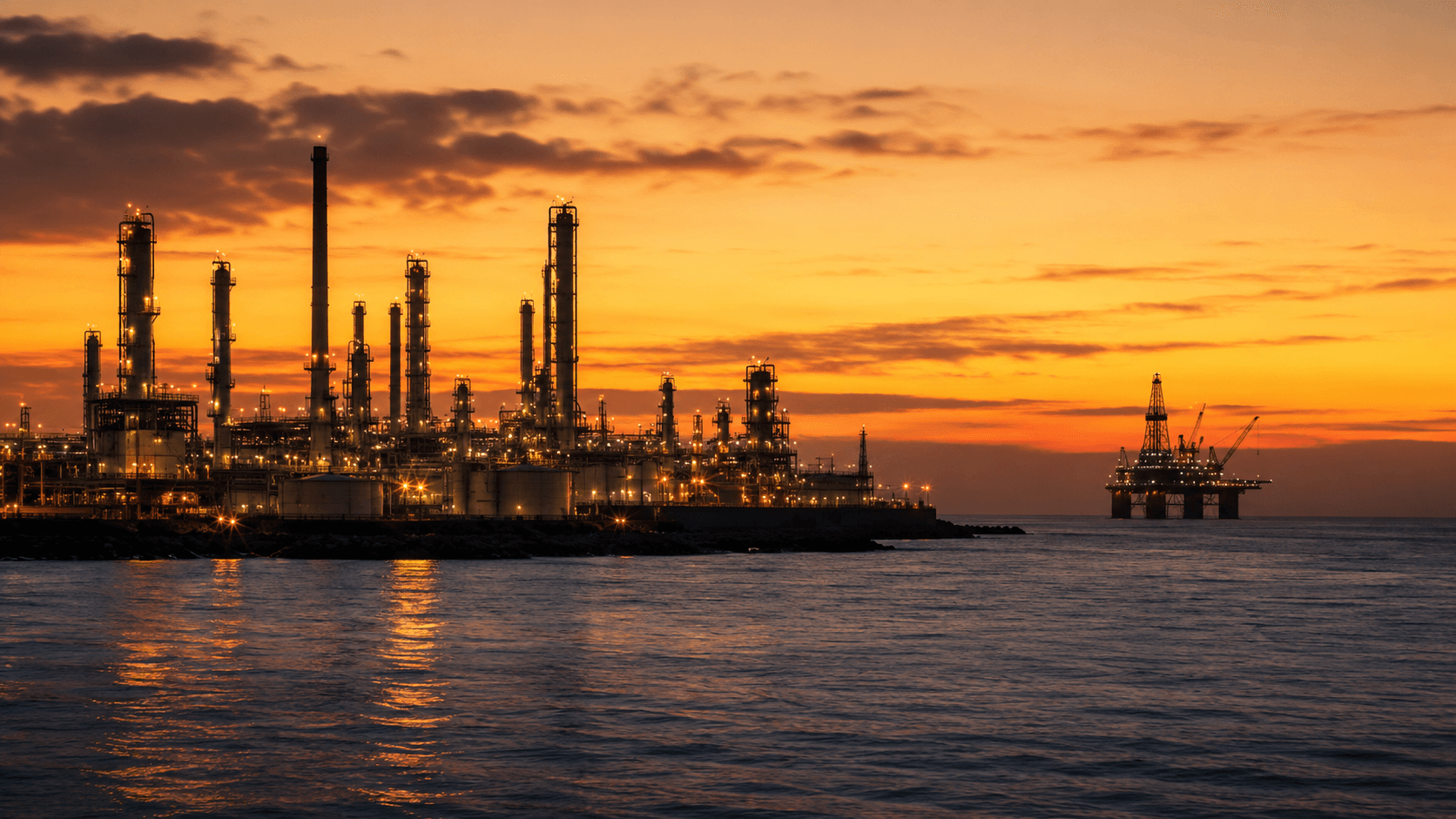 Coastal oil and gas facility at dusk - the critical-asset environments behind ISIT's sector heritage